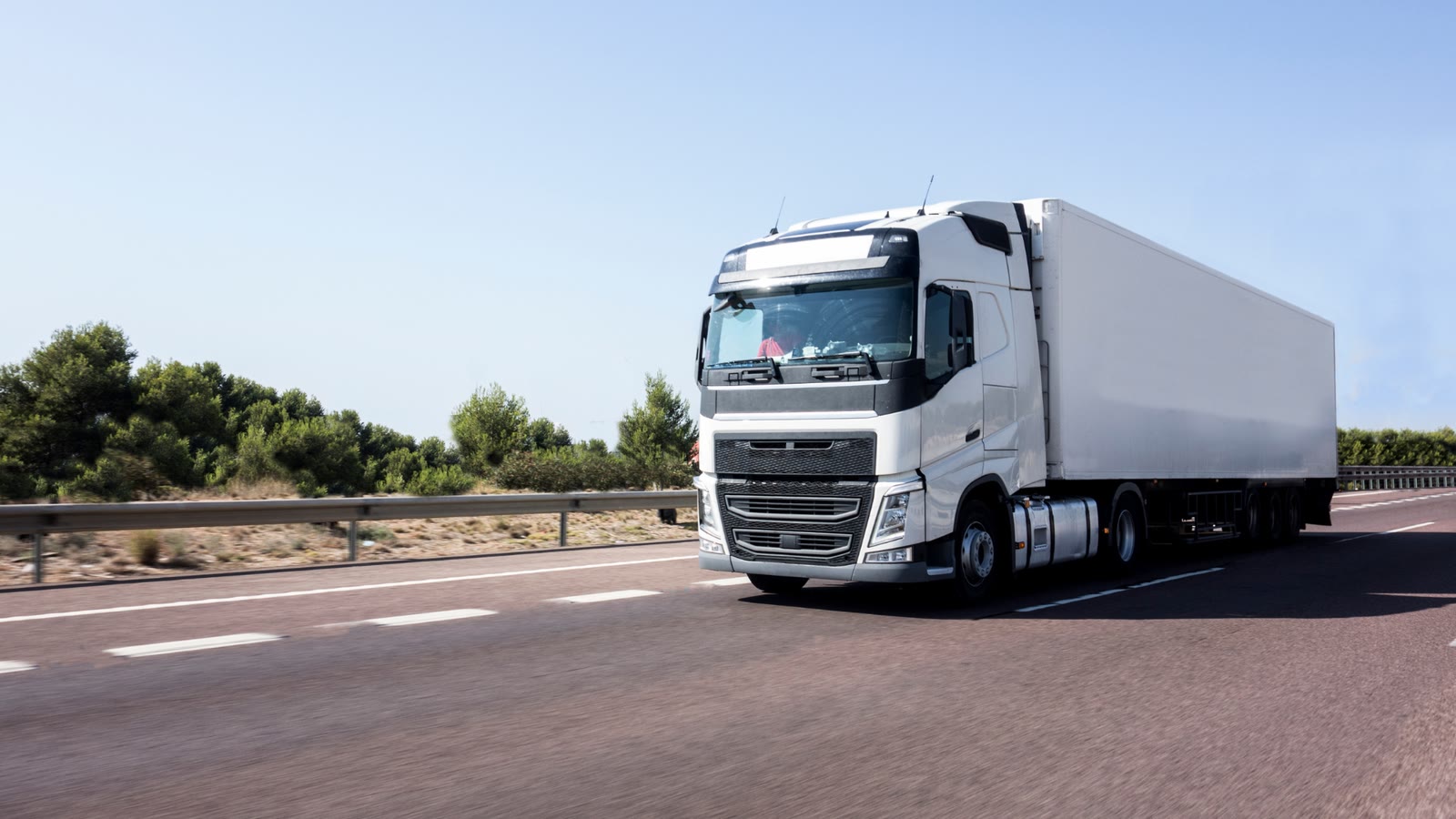 QLOGIX Transports truck on a European motorway in bright daylight